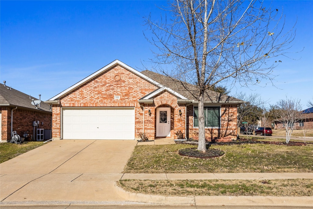 ranch-style home with a garage and a front lawn