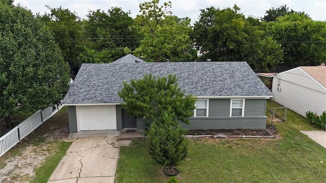 view of front of house featuring a garage and a front lawn