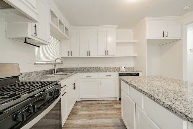 kitchen featuring dishwasher, white cabinetry, sink, light stone countertops, and gas range oven