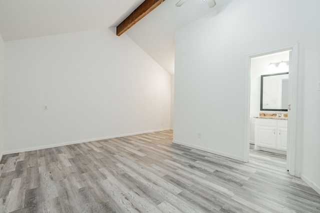 unfurnished room with beam ceiling, high vaulted ceiling, and light wood-type flooring