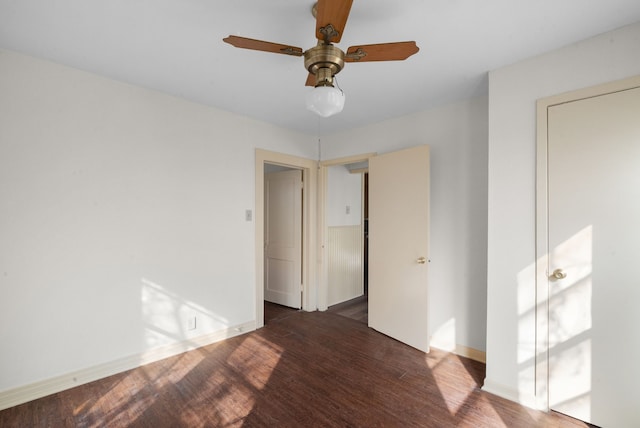 empty room featuring ceiling fan and dark hardwood / wood-style flooring