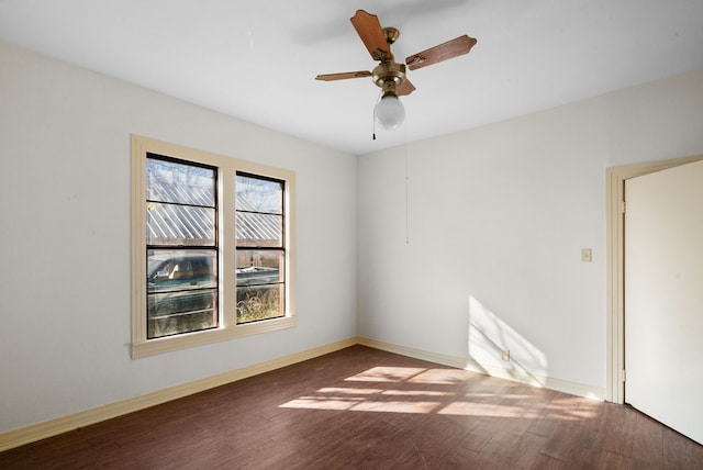 spare room featuring ceiling fan, plenty of natural light, and dark hardwood / wood-style floors