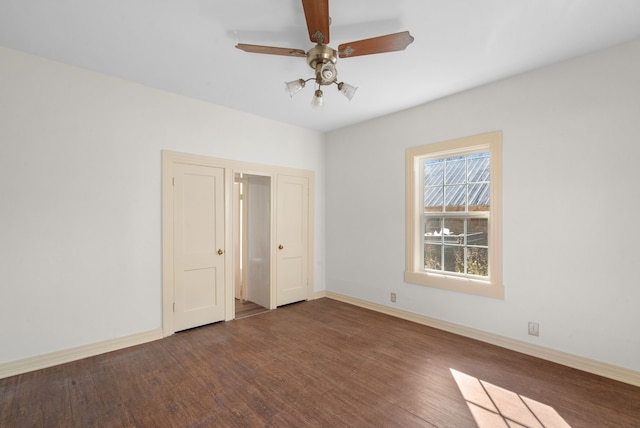 unfurnished room with dark hardwood / wood-style floors and ceiling fan