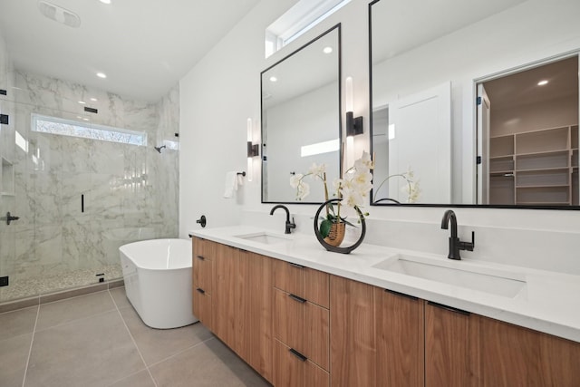 bathroom featuring vanity, independent shower and bath, and tile patterned flooring