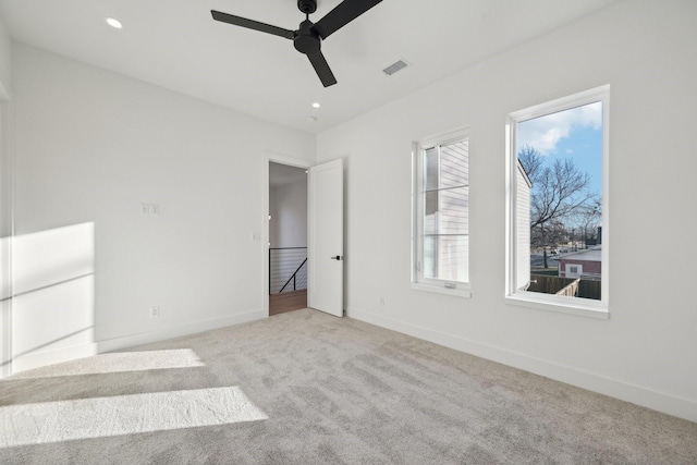 unfurnished bedroom featuring light carpet and ceiling fan