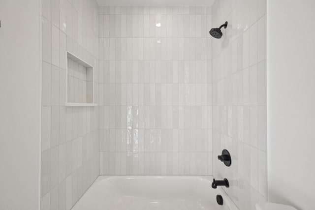 bathroom featuring tiled shower / bath