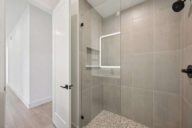 bathroom featuring a shower with shower door