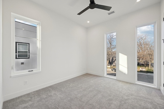 carpeted empty room featuring ceiling fan