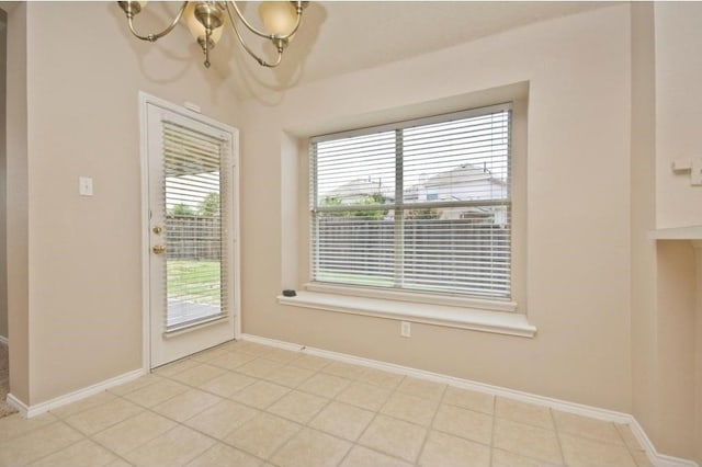 interior space with light tile patterned flooring and a notable chandelier