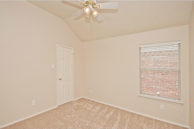 carpeted spare room with ceiling fan and lofted ceiling