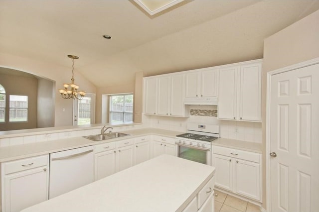 kitchen with lofted ceiling, sink, white cabinetry, kitchen peninsula, and white appliances