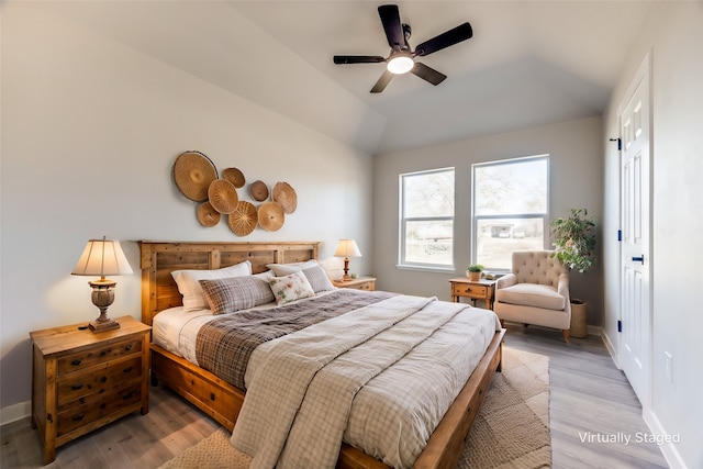 bedroom with vaulted ceiling, wood-type flooring, and ceiling fan