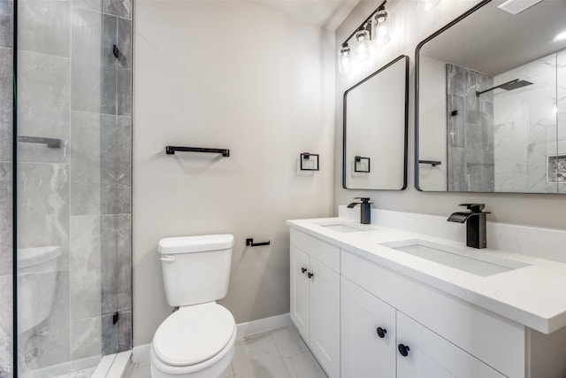 bathroom with vanity, a shower with shower door, and toilet