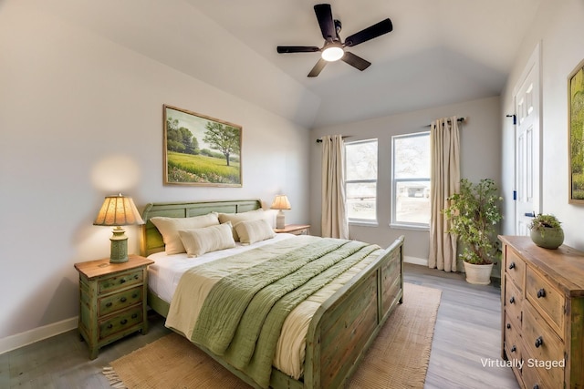 bedroom featuring vaulted ceiling, ceiling fan, and light wood-type flooring