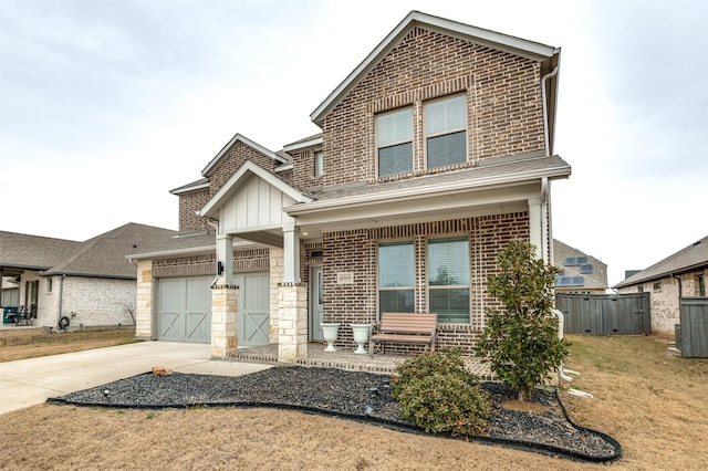 view of front facade with a garage, covered porch, and a front lawn