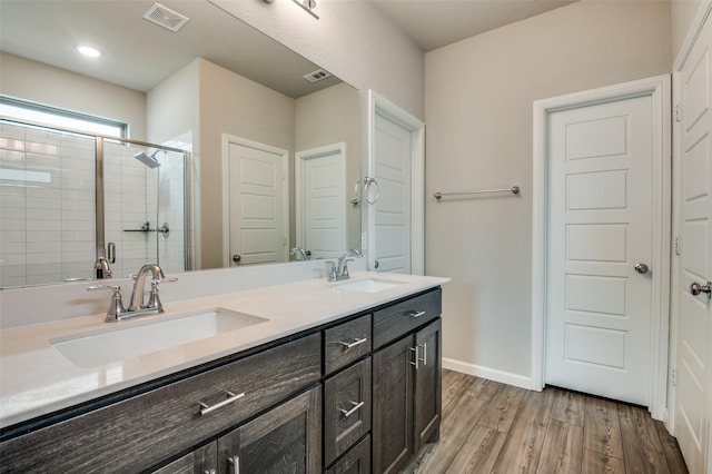 bathroom with vanity, hardwood / wood-style floors, and walk in shower