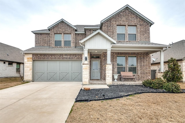 view of front of house with a garage, a porch, and a front yard