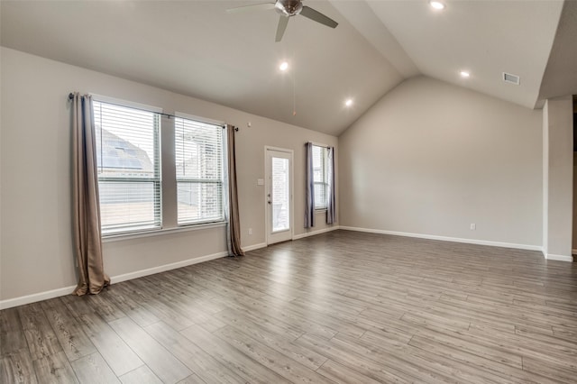 spare room with ceiling fan, lofted ceiling, and light hardwood / wood-style floors