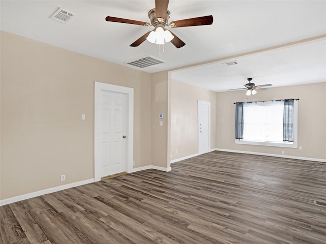 spare room featuring dark wood-type flooring and ceiling fan