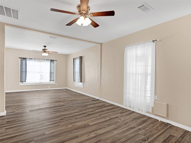 spare room with dark hardwood / wood-style floors and ceiling fan