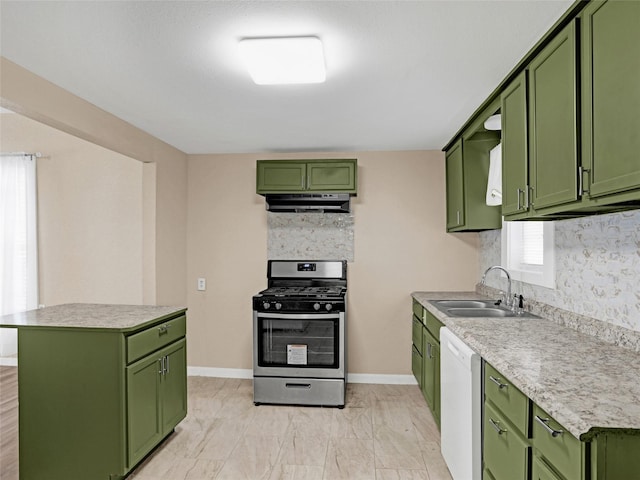 kitchen featuring dishwasher, sink, decorative backsplash, green cabinets, and stainless steel gas range