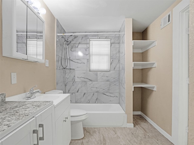 full bathroom with vanity, toilet, and tiled shower / bath combo