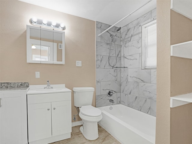 full bathroom featuring tiled shower / bath combo, vanity, and toilet