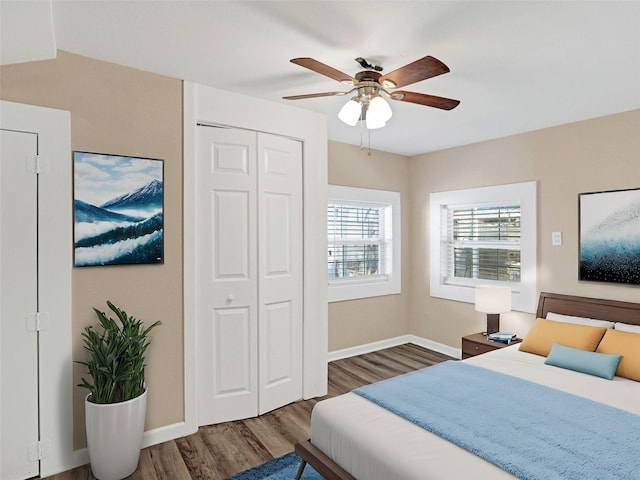 bedroom featuring a closet, dark hardwood / wood-style floors, and ceiling fan