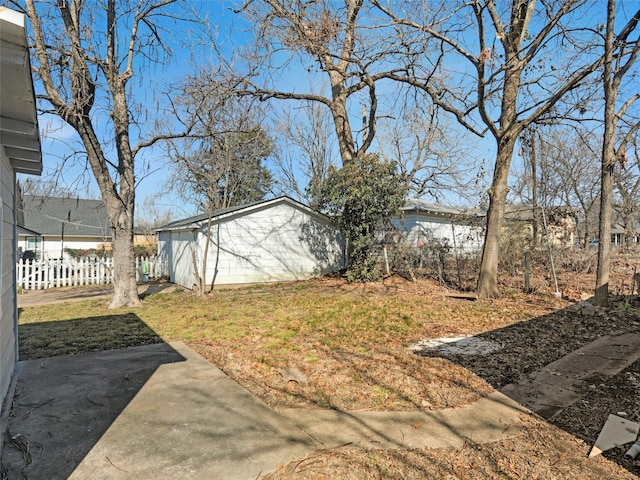 view of yard featuring a patio and an outdoor structure