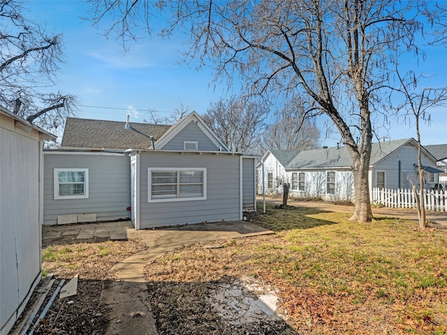 rear view of house featuring a yard and a patio