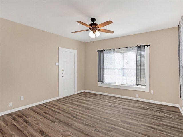 unfurnished room with dark hardwood / wood-style flooring and ceiling fan