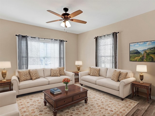 living room with light hardwood / wood-style floors and ceiling fan