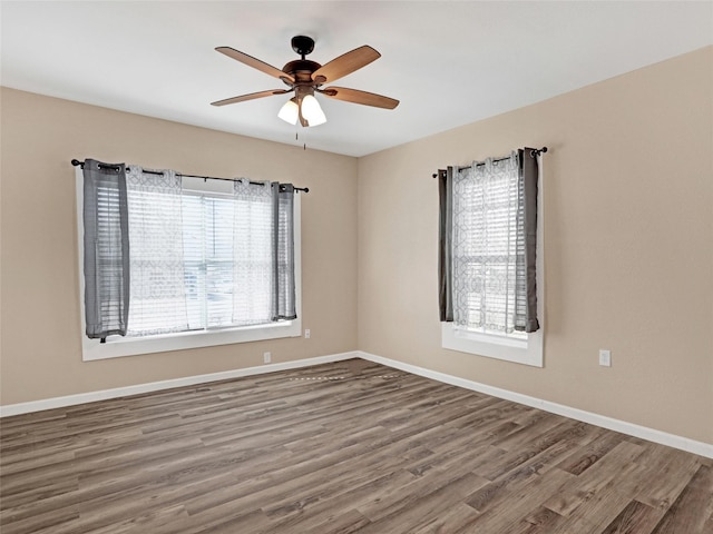 empty room featuring hardwood / wood-style flooring and ceiling fan