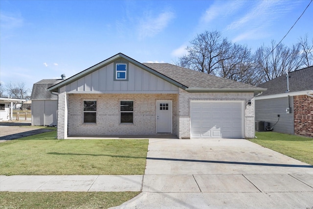 view of front of property with central AC unit, a garage, and a front yard