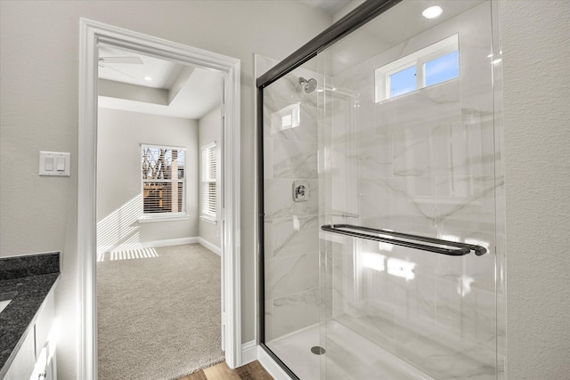 bathroom with vanity and a shower with door