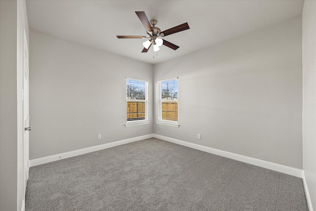 carpeted spare room featuring ceiling fan