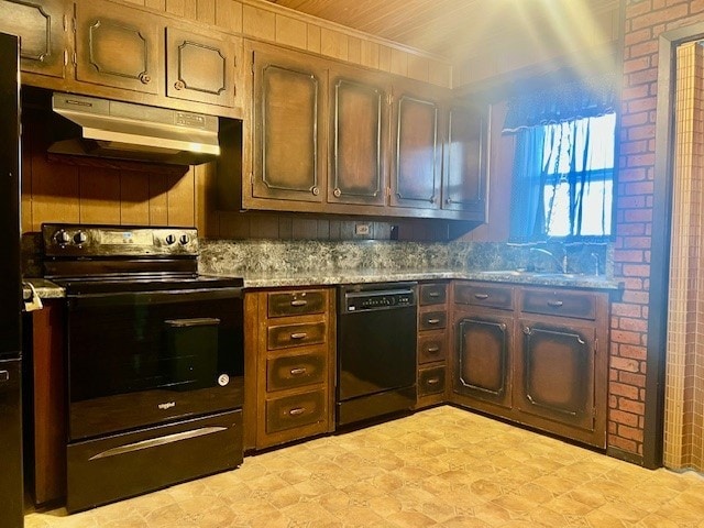 kitchen with light stone countertops, sink, and black appliances