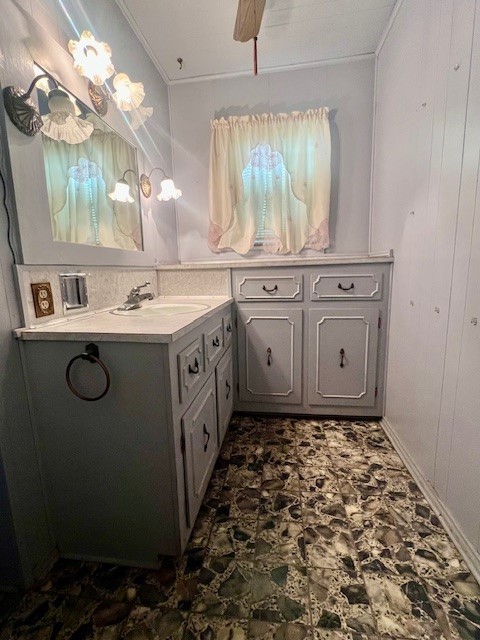 bathroom with vanity, ornamental molding, ceiling fan, and wooden walls