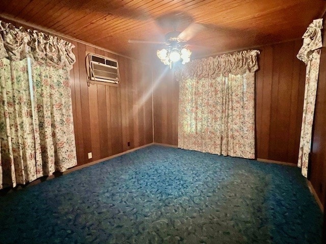 carpeted empty room with a wall mounted air conditioner, wooden walls, and ceiling fan