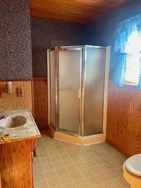 bathroom with wooden walls, vanity, an enclosed shower, wooden ceiling, and toilet