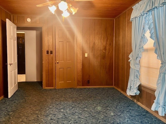 spare room featuring wooden ceiling and wooden walls