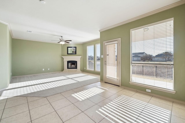 unfurnished living room featuring ornamental molding, light tile patterned floors, and ceiling fan