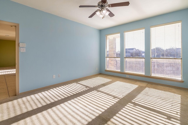 unfurnished room featuring ceiling fan and light carpet