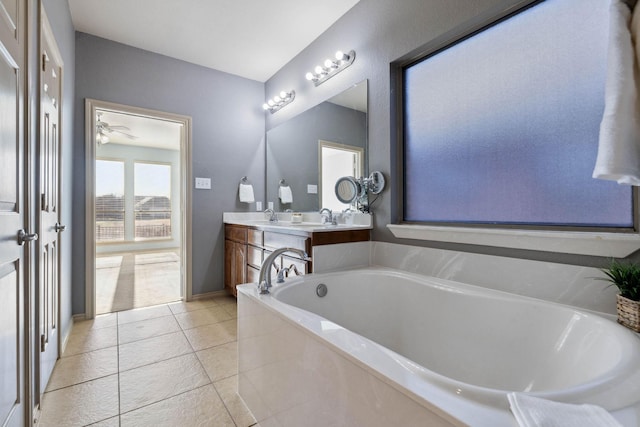 bathroom with vanity, a bath, and tile patterned floors