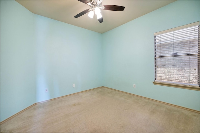 spare room featuring carpet flooring and ceiling fan