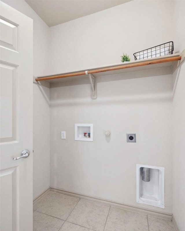 laundry room featuring gas dryer hookup, hookup for an electric dryer, hookup for a washing machine, and light tile patterned floors