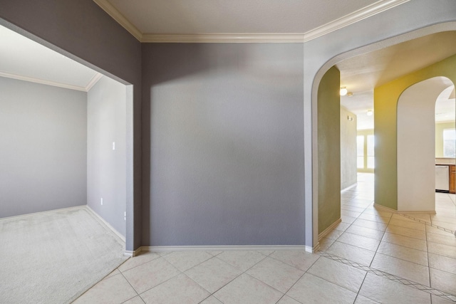 spare room with light tile patterned flooring and crown molding