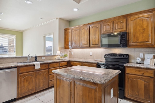 kitchen featuring sink, light stone counters, light tile patterned floors, a kitchen island, and black appliances