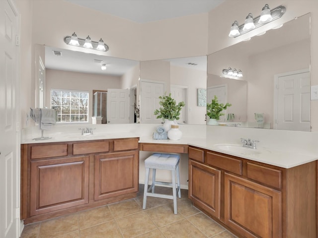 bathroom featuring tile patterned flooring, vanity, and a shower with door