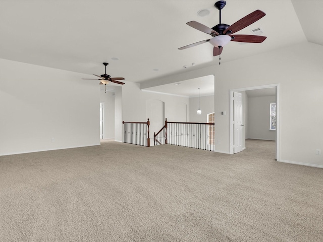 carpeted spare room with vaulted ceiling and ceiling fan